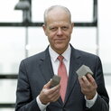 Ein Mann hält viereckige Metallstrukturen in den Händen