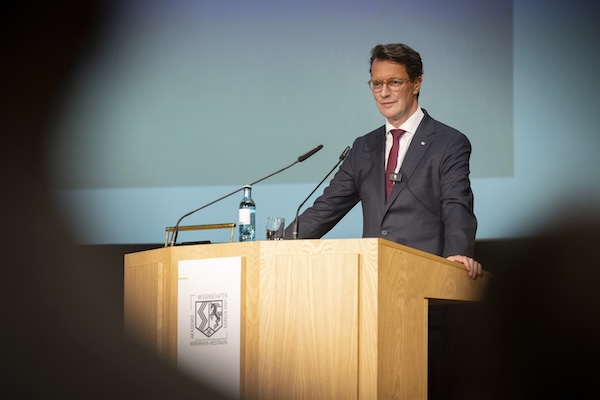 NRW-Ministerpräsident Hendrik Wüst steht an einem Rednerpult.  